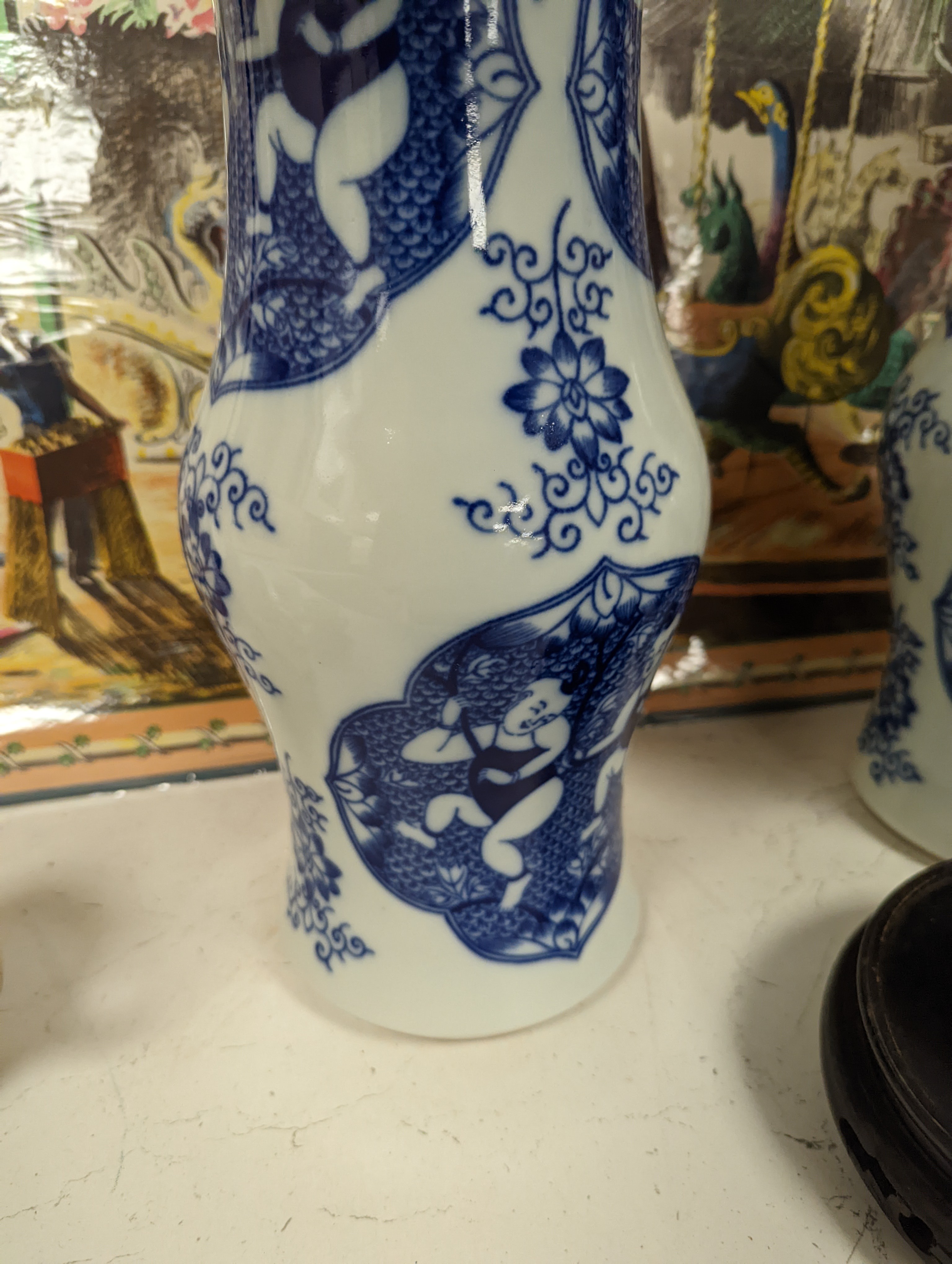 A pair of Chinese blue and white vases on stands and 6 further wood stands. Vases 35cm
